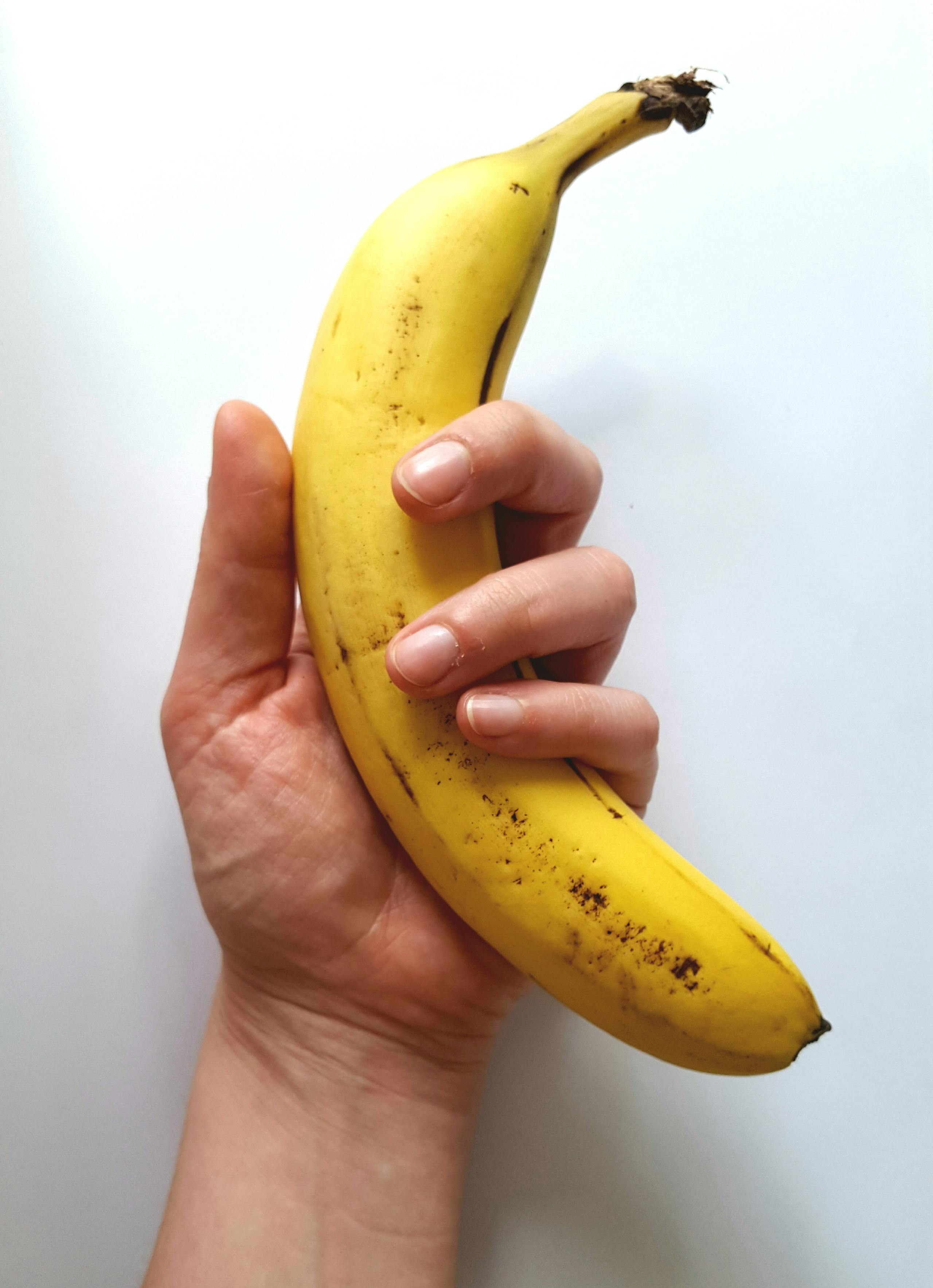 Yellow Banana on Hand · Free Stock Photo