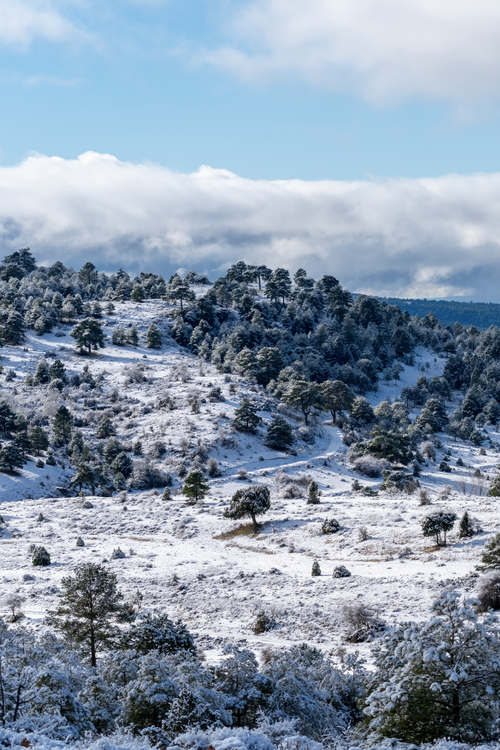Free Stunning winter landscape of snow-covered hills in Huerta del Marquesado, Spain. Stock Photo