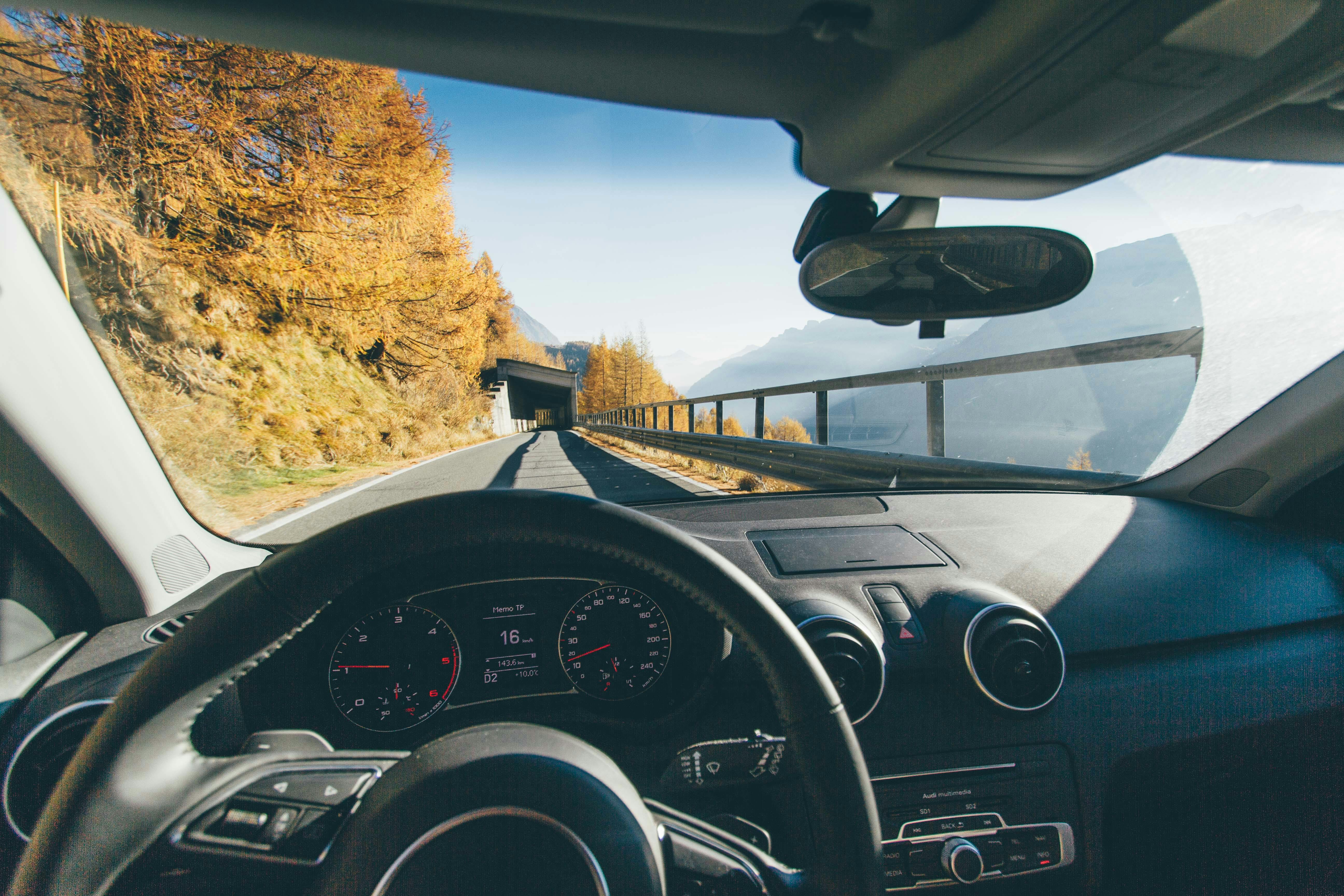 An upcoming tunnel on a road through a windshield