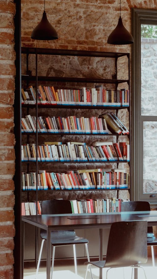 A room with a table and chairs and bookshelves