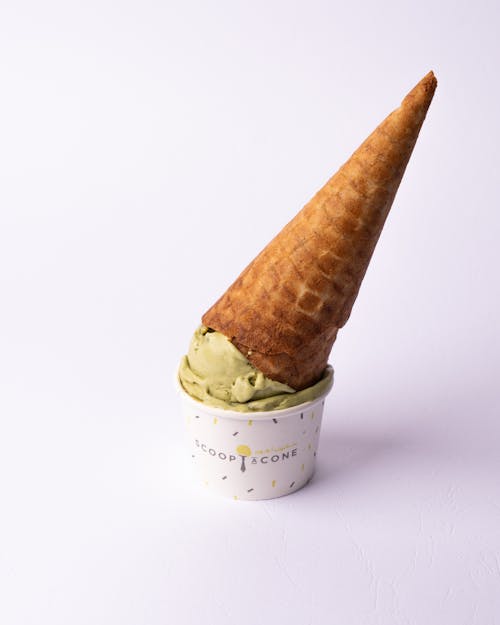 A cone with a green ice cream on top