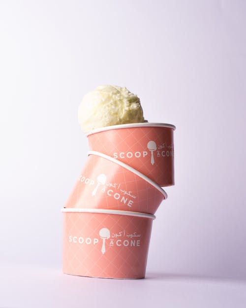 Ice cream in pink cups with a cone on top