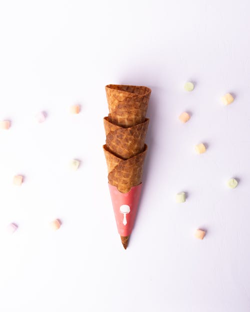 A cone with sprinkles and candy hearts