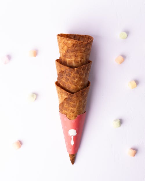 A cone with ice cream and candy hearts