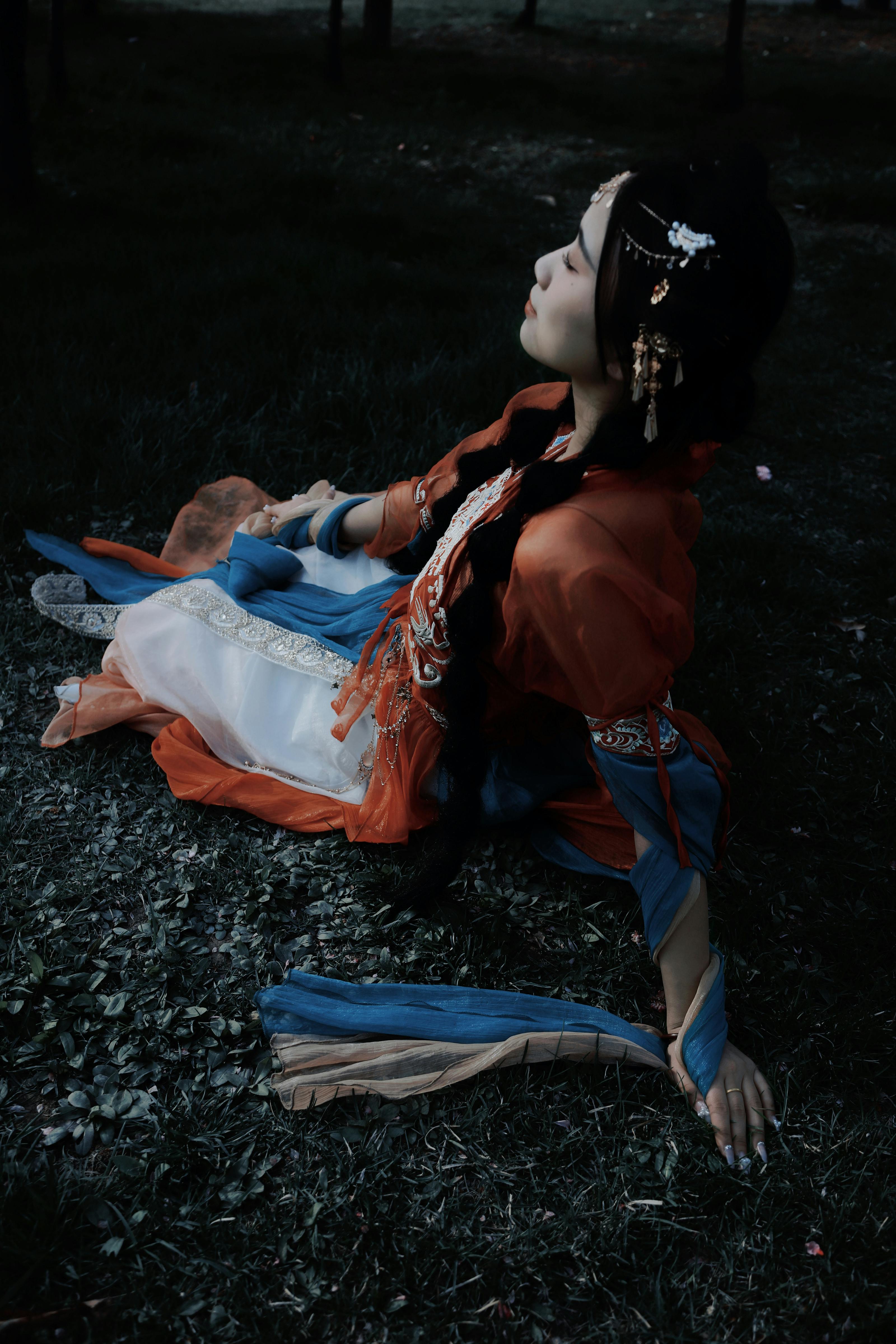 woman in hanfu dress lying on ground