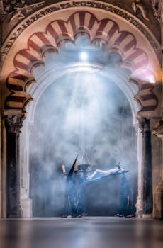 Atmospheric scene of a religious procession with capirotes in Córdoba's Mezquita, shrouded in mystery.