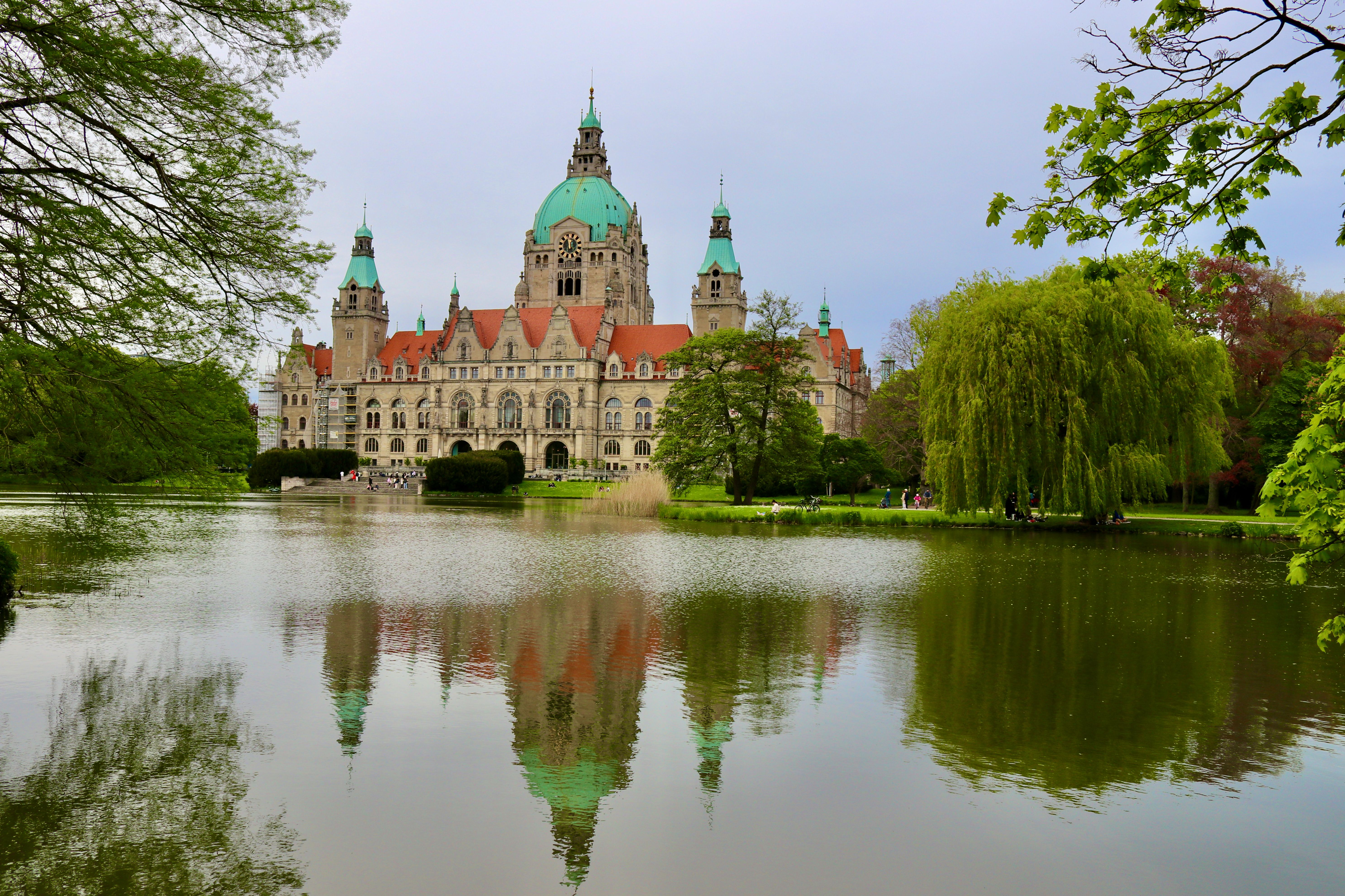 Explore the stunning New Town Hall in Hannover, reflected in serene lake waters.