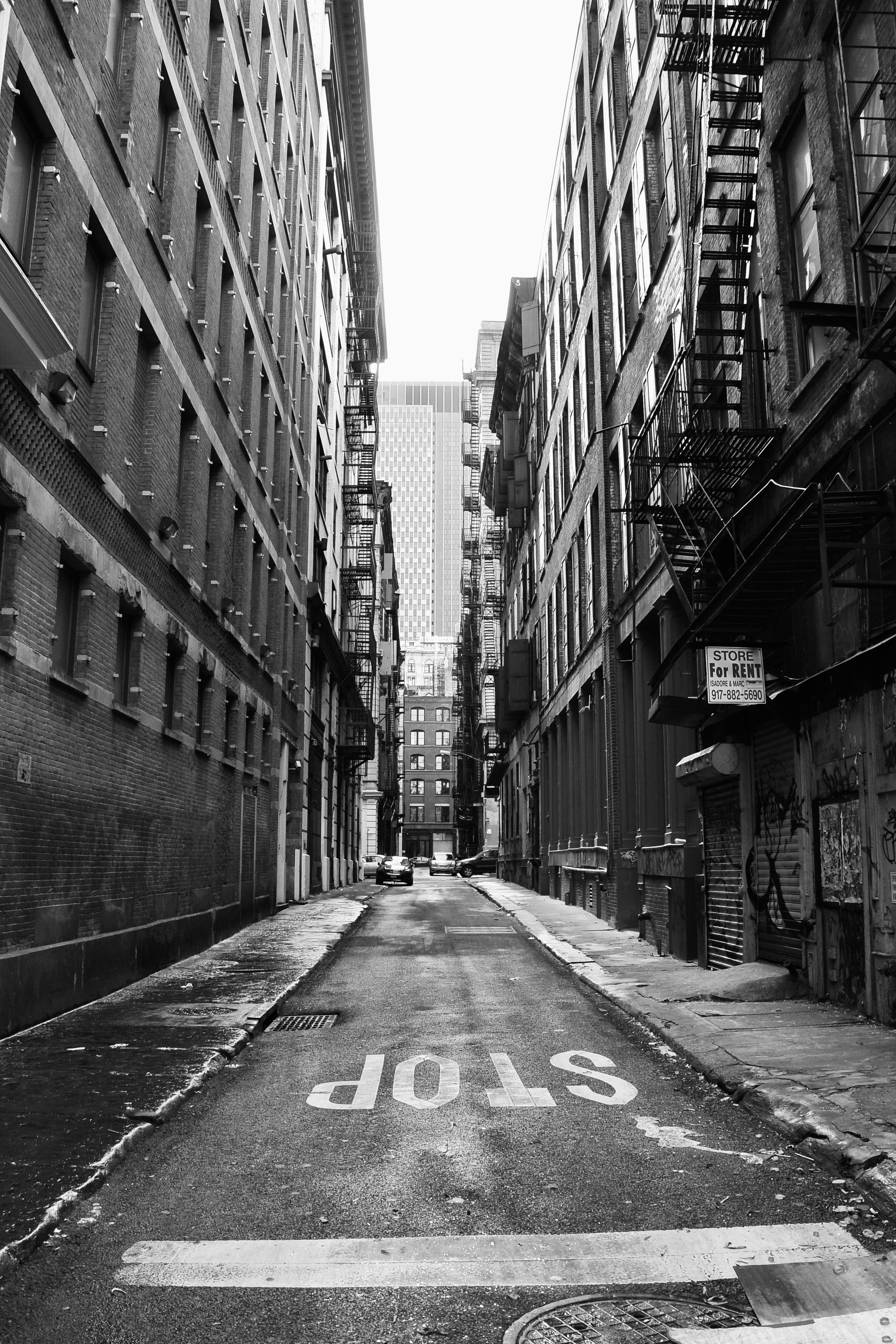 one way narrow street between new york apartment buildings