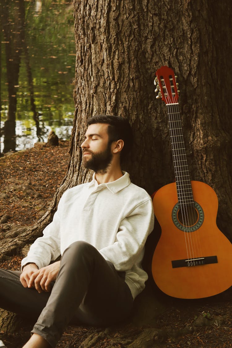 Man With A Guitar In A Park