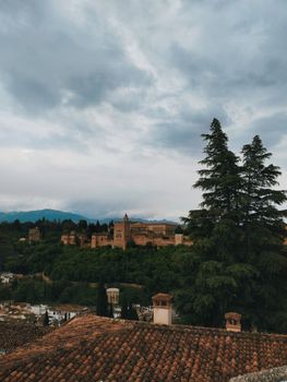 Breathtaking view of the historic Alhambra Palace with lush greenery in Granada, Spain.