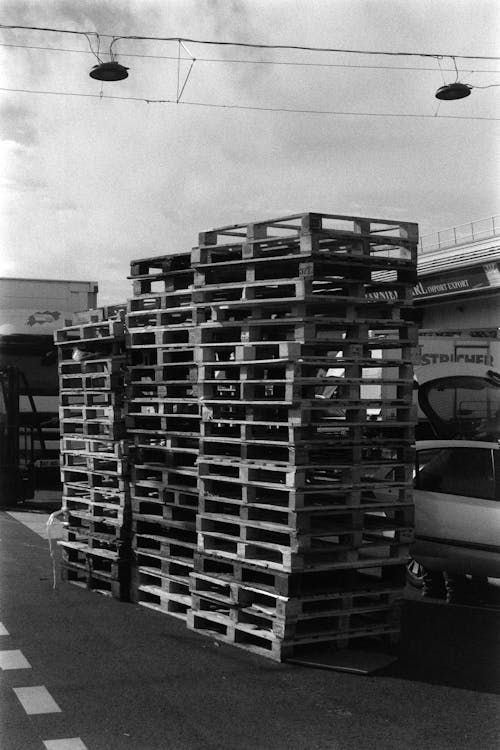 A black and white photo of a pile of pallets