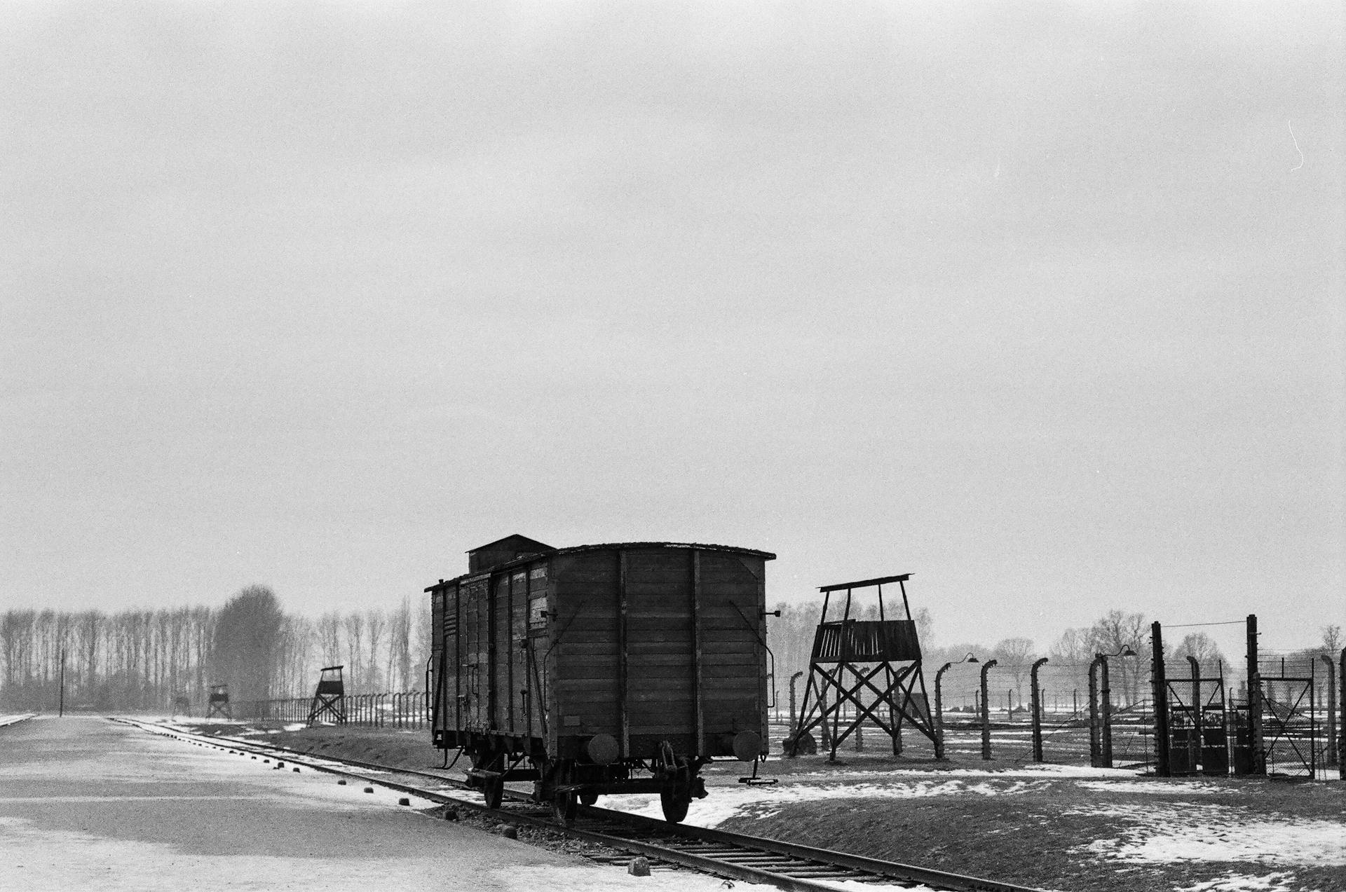 A Wooden Train Wagon and Watchtowers at the Auschwitz Birkenau Concentration Camp