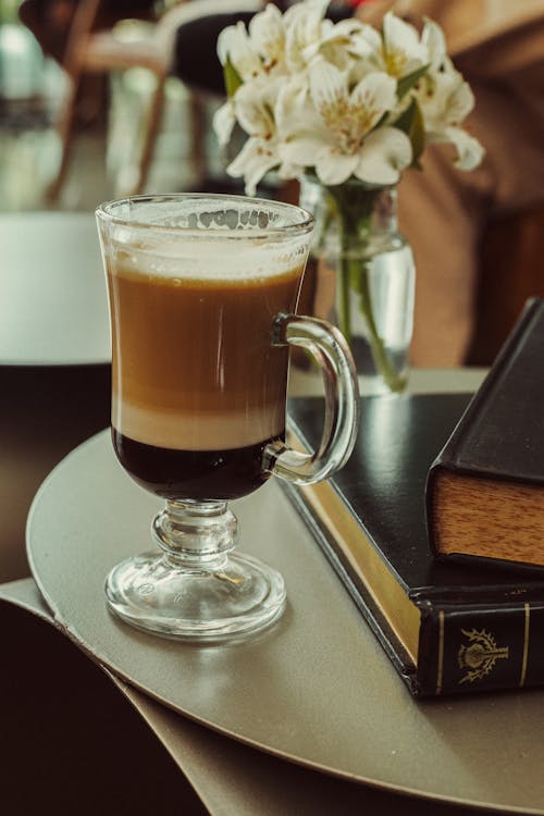 A coffee cup with a book on a table