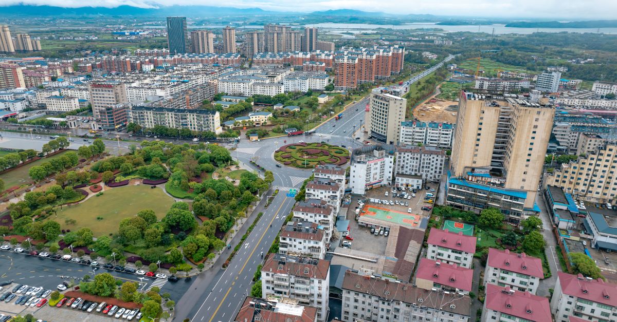 Aerial photograph capturing the vibrant cityscape of Jiujiang, Jiangxi, China showcasing residential and commercial buildings.