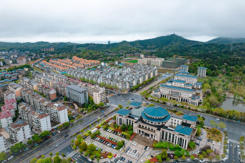 Breathtaking 1 Day Beijing Badaling Great Wall Helicopter Tour Review 2026 - Aerial view of Jiu Jiang Shi showing urban architecture and scenic greenery in Jiang Xi Sheng, China.