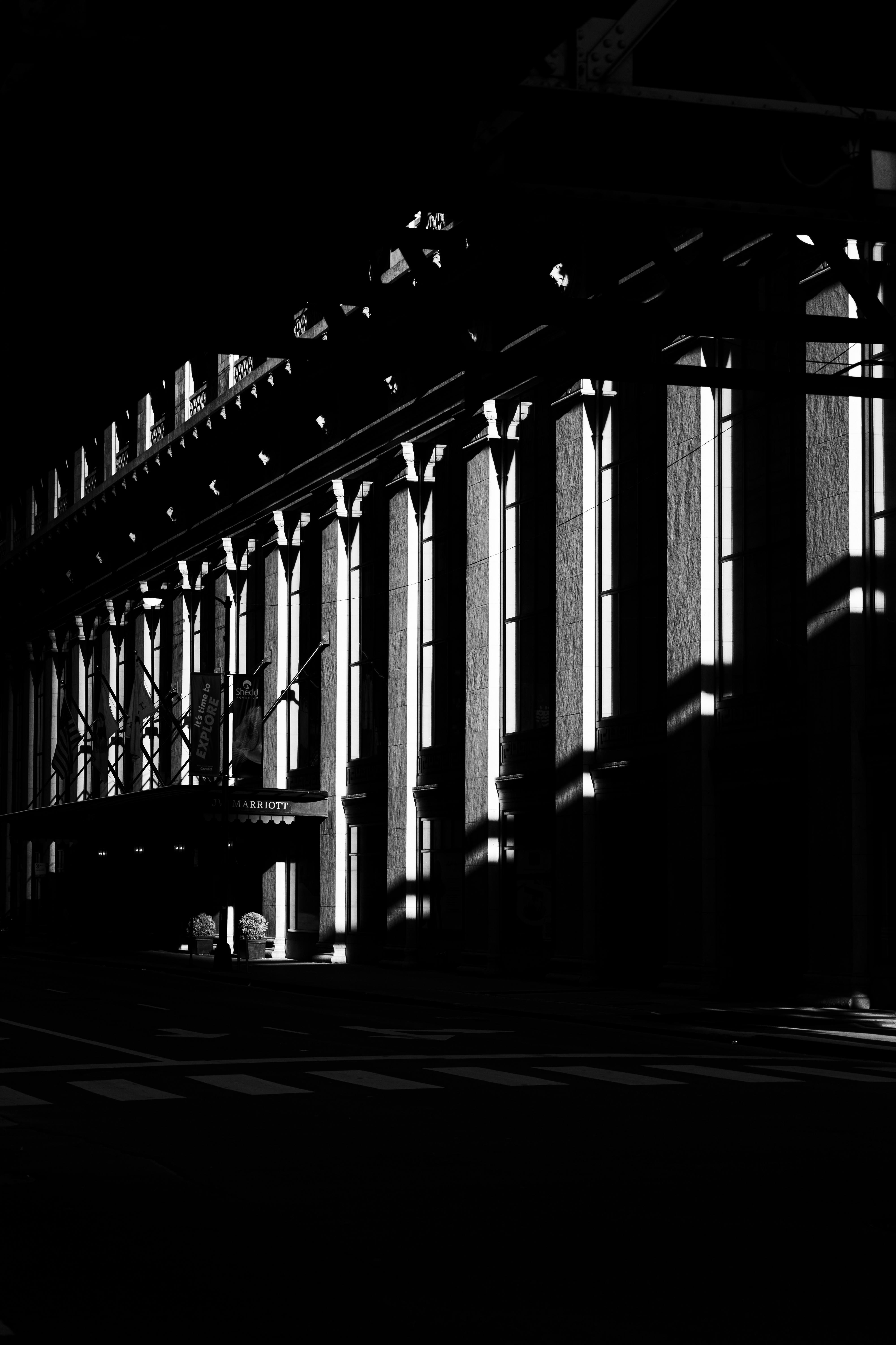 A sunlit building facade casting dramatic shadows on a street in Chicago.