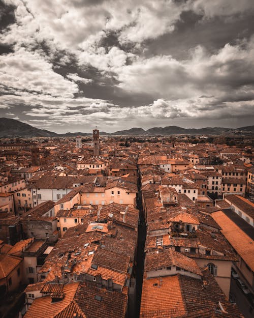 Aerial View of Buildings Under Cloudy Sky