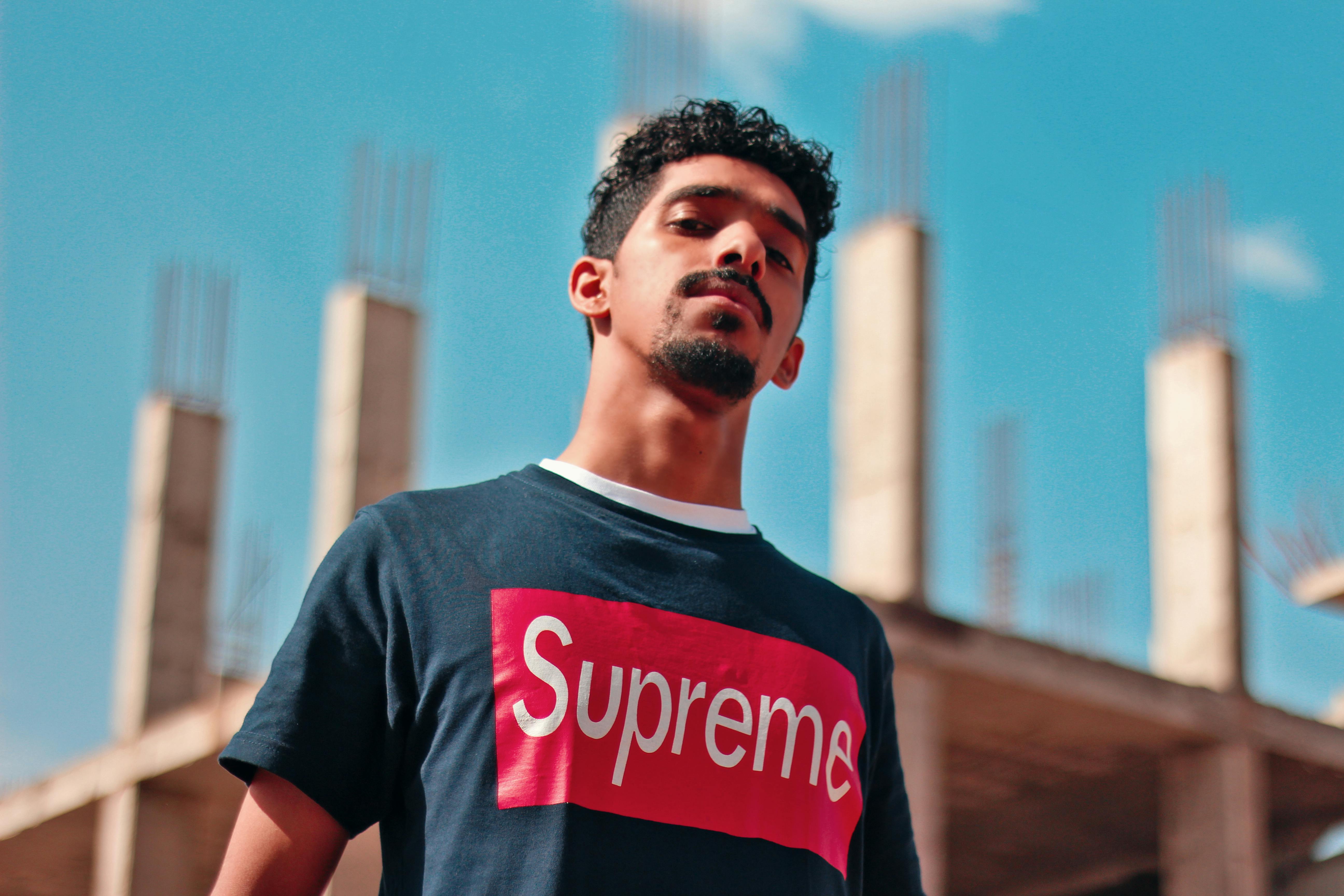 red and blue supreme shirt