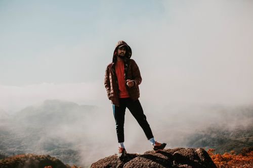 Free A person standing on a mountain top enveloped in mist at Bairro Alto, Brazil, showcasing outdoor adventure. Stock Photo
