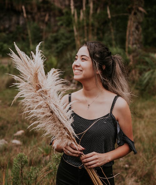 Woman Standing on Grass Field