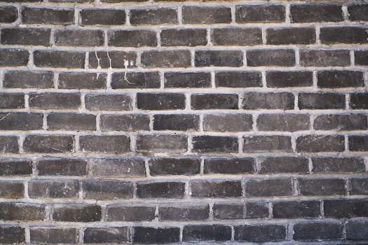 Close-up of a dark brick wall showing texture and cement for backgrounds or design.