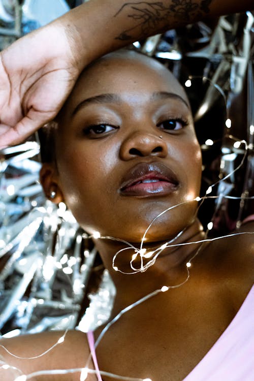 A woman with a pink shirt and silver lights