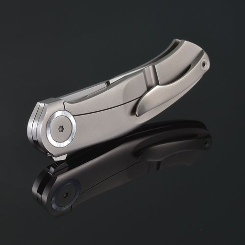 Free A sleek, folded stainless steel pocket knife with a mirror reflection. Stock Photo