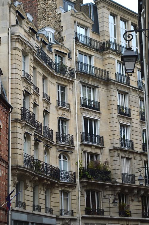 Free Elegant facade of Parisian apartment buildings with unique balconies in Saint-Michel, France. Stock Photo