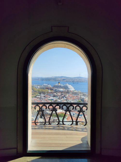 Free A stunning view of Istanbul's coastline and a cruise ship through a historic arched window. Stock Photo