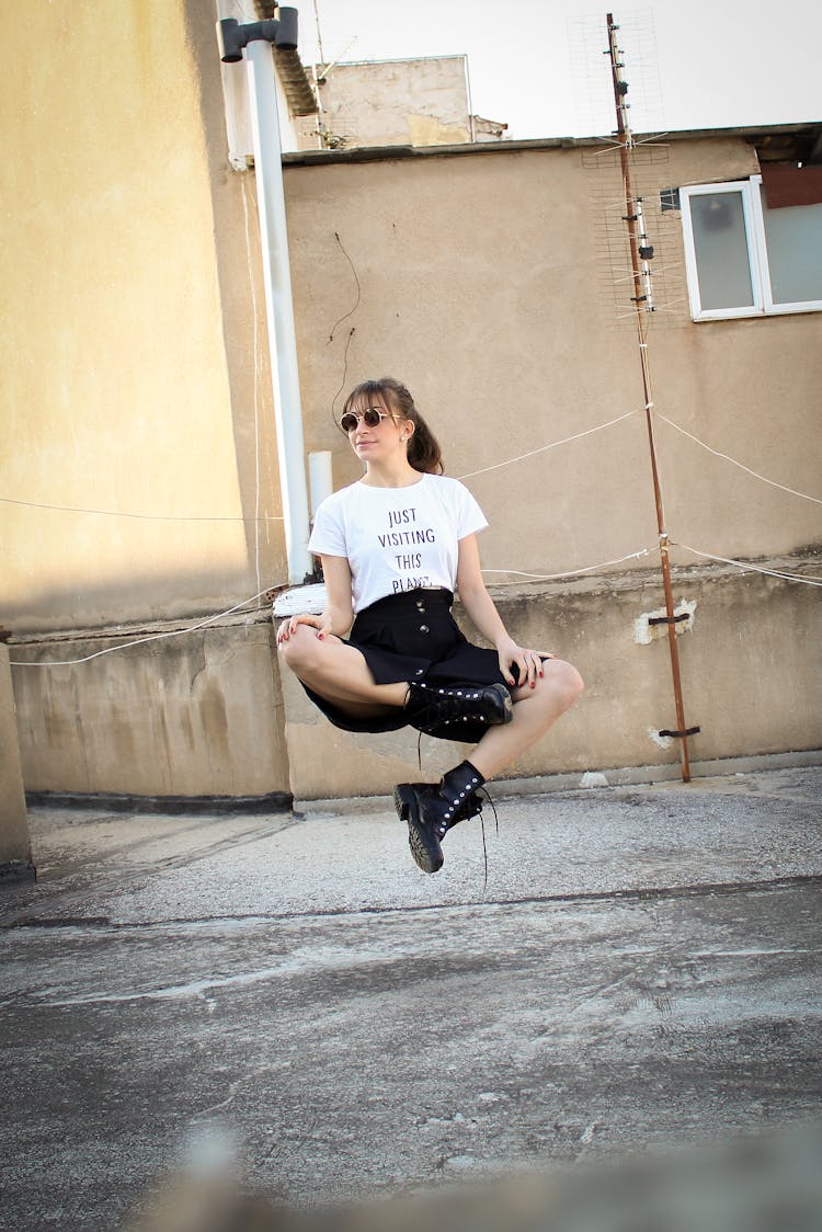 Woman Floating Near Beige Wall