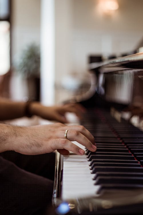 Person Wearing Ring Playing Piano