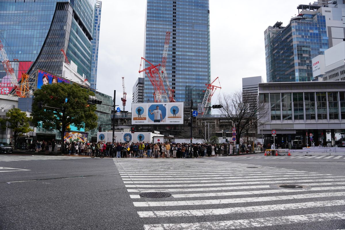 Tokyo Shibuya crossing at night with neon lights