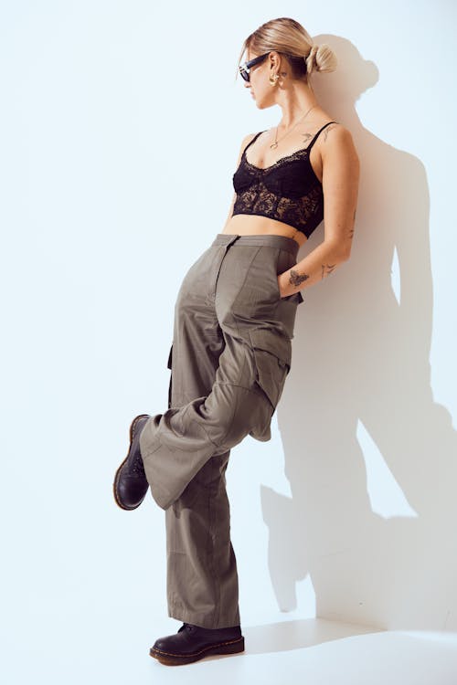 A woman in a crop top and cargo pants