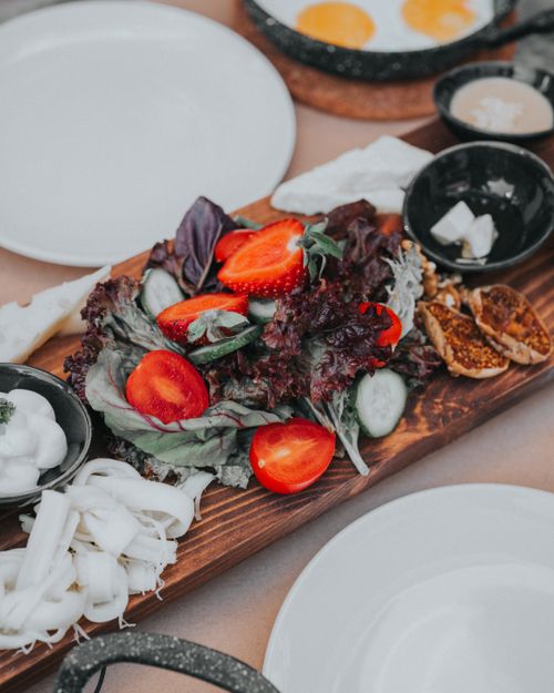 Free Vibrant salad platter served with various fresh vegetables, cheese, and figs. Stock Photo