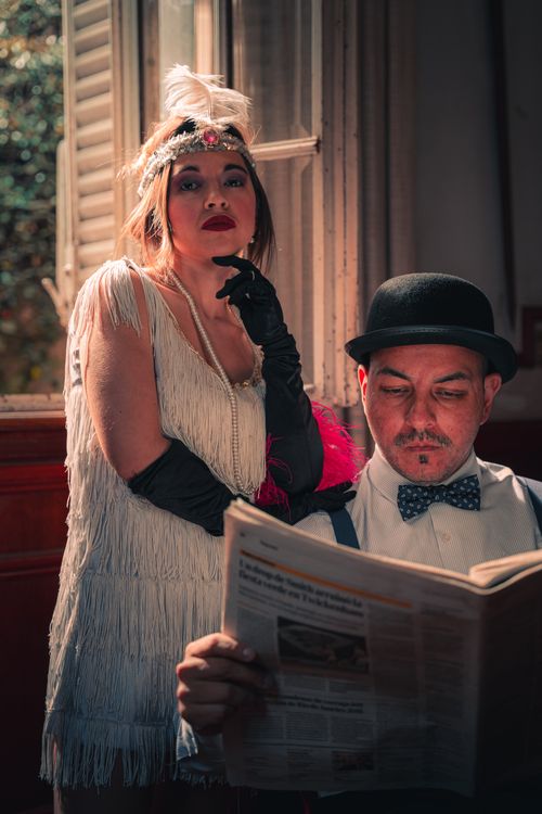 Free A man and woman dressed in vintage attire, indoors, creating a timeless retro ambience. Stock Photo