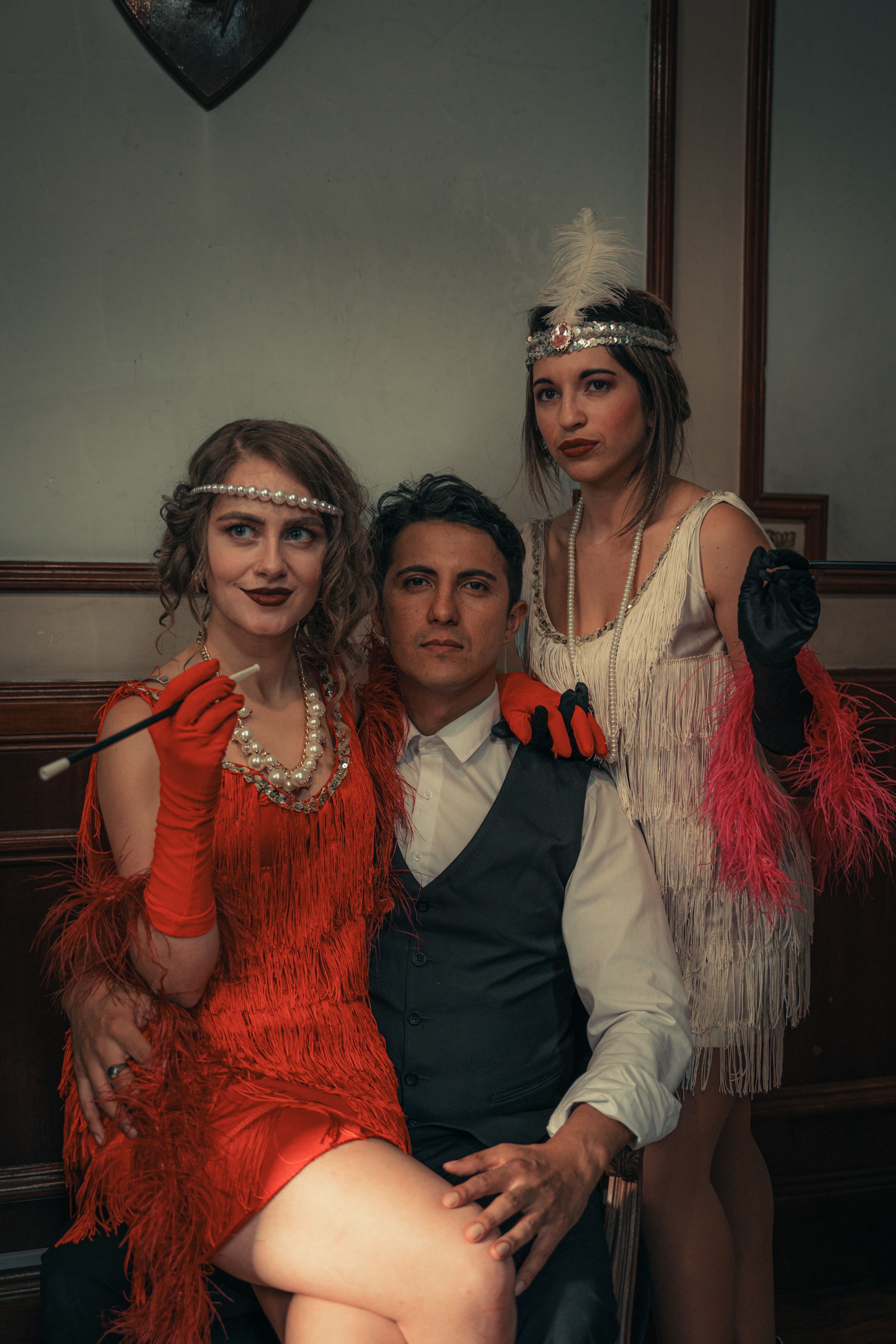 Stylish 1920s-themed group portrait featuring elegant flapper dresses and retro fashion.