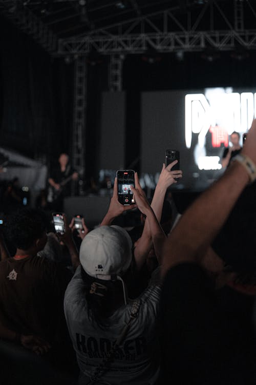 A crowd of people taking pictures at a concert