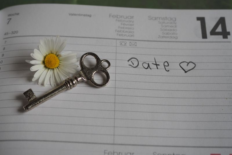 Planner page with daisy flower and vintage key symbolizing romance and Valentine's Day plans.