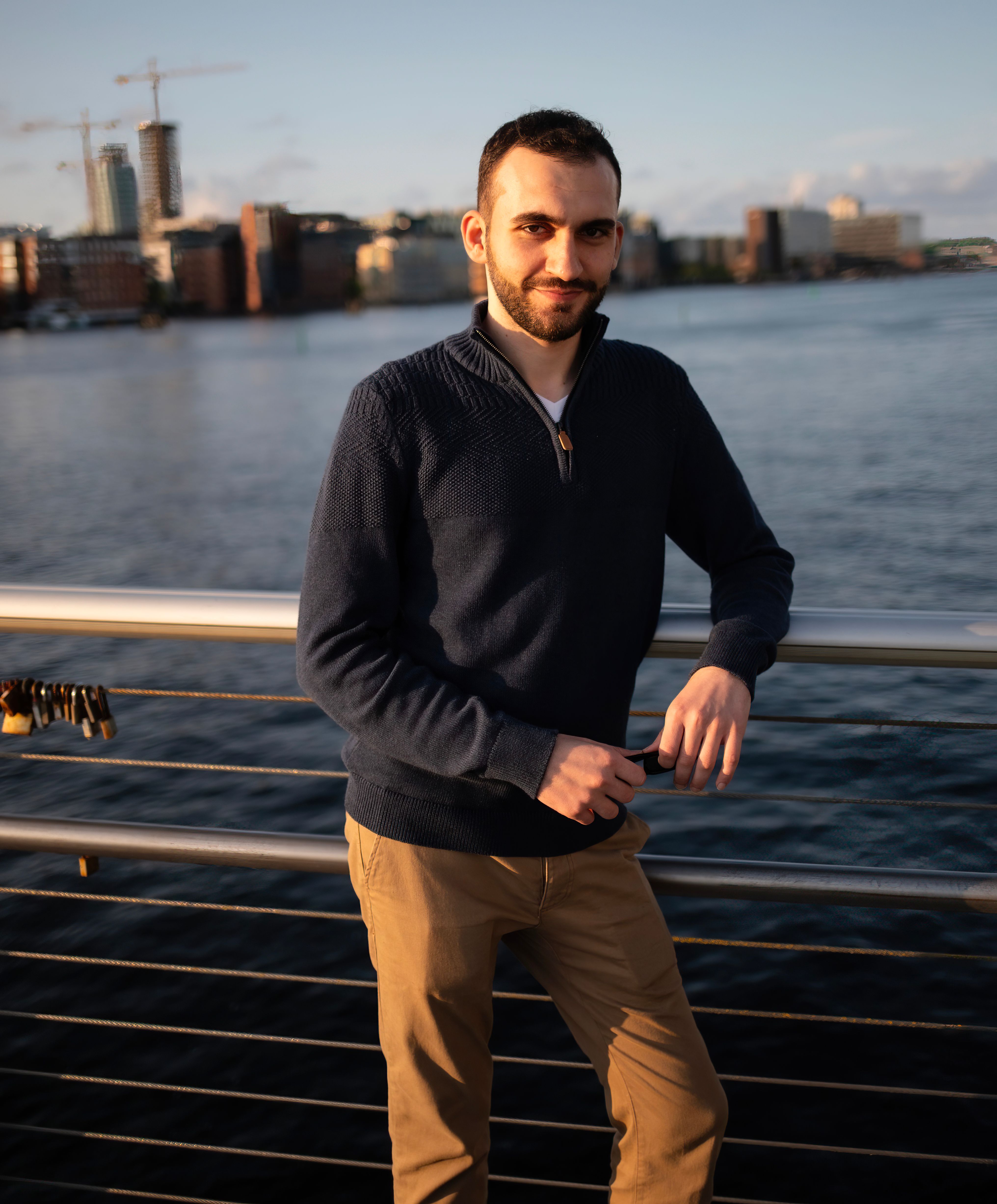 Man Leaning Against a Railing Against Cityscape Background · Free Stock ...
