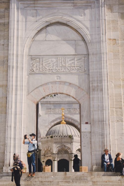 Free Tourists at the entrance of Suleymaniye Mosque, Istanbul, capturing its intricate architecture. Stock Photo