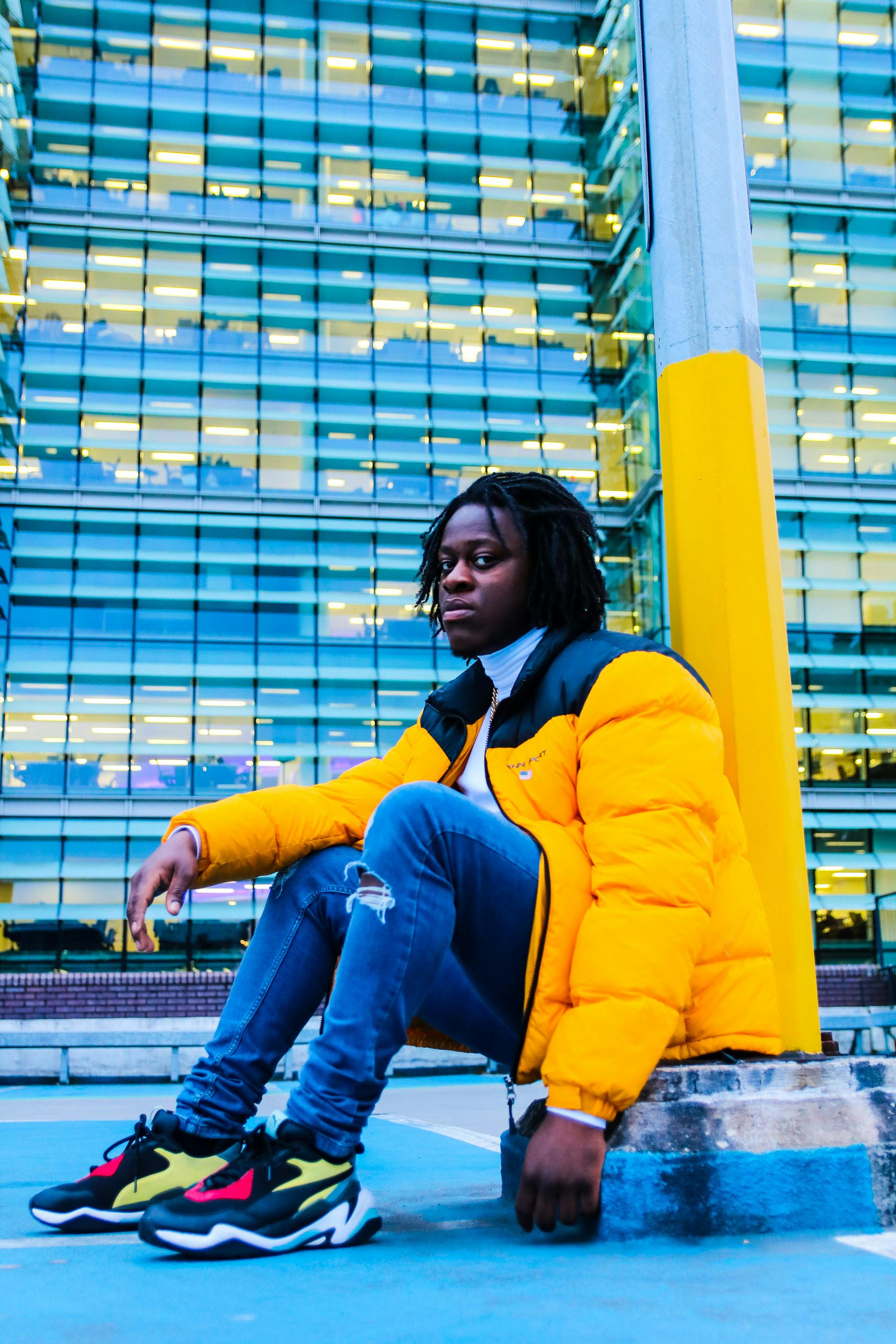 一位穿着活力夹克的时尚黑人在伯明翰的城市环境中摆姿势