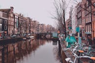 阿姆斯特丹运河风景如画，两岸排列着历史建筑，自行车与充满活力的城市生活点缀其间