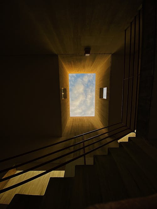 A stairway leading up to a sky light