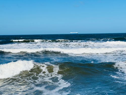 Free stock photo of beach waves, blue ocean, blue sky Stock Photo