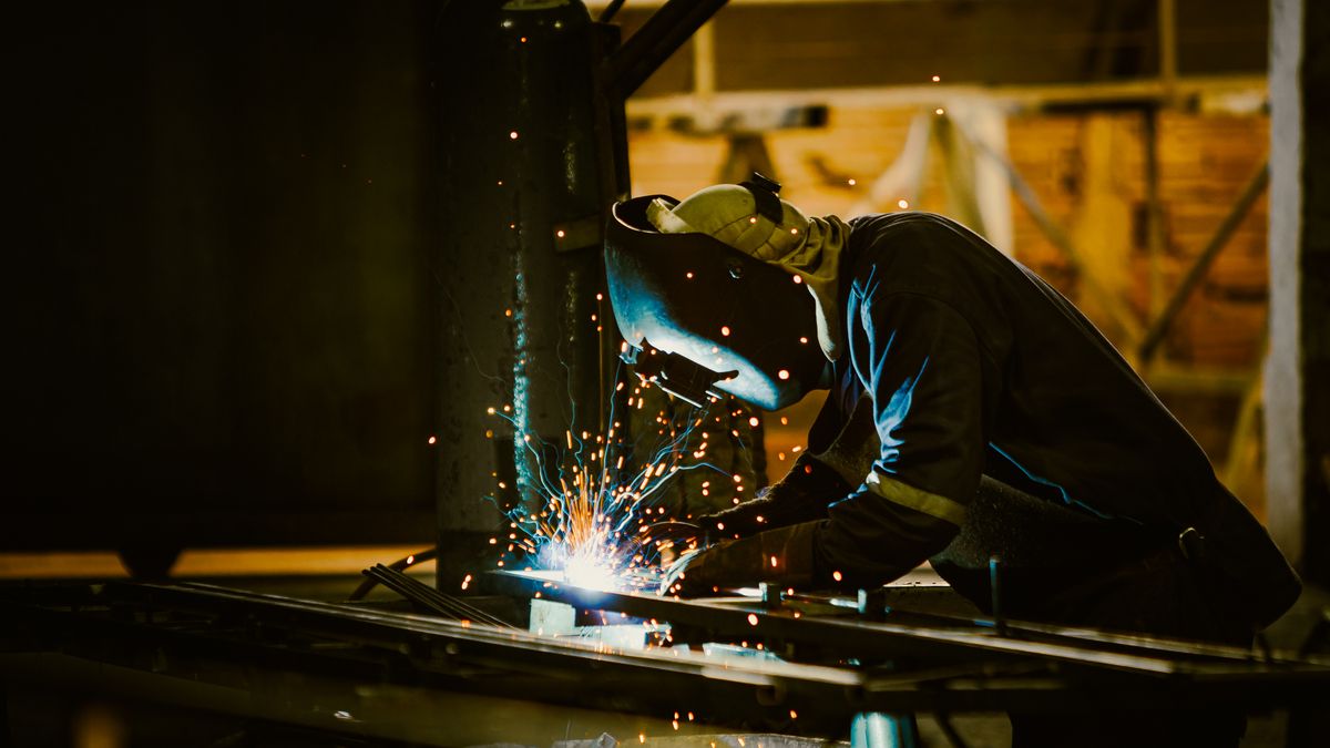 Welder fabricating with sparks flying