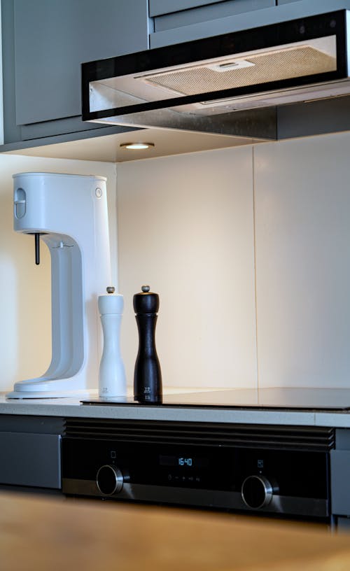 A kitchen with a white stove and a coffee maker