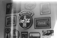 A black and white photo of a coca cola sign