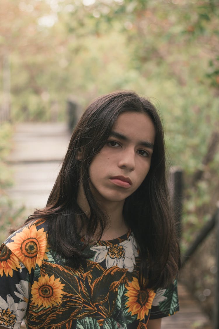 Young Androgynous Man On Walkway In Nature