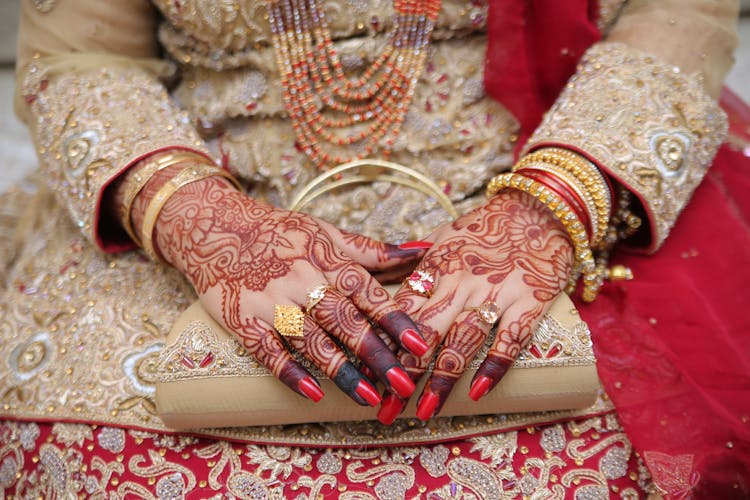 Hands With Gold, Diamonds And Red Nails