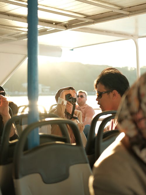 A group of people on a bus taking pictures
